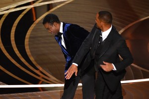 TOPSHOT - US actor Will Smith (R) slaps US actor Chris Rock onstage during the 94th Oscars at the Dolby Theatre in Hollywood, California on March 27, 2022. (Photo by Robyn Beck / AFP) (Photo by ROBYN BECK/AFP via Getty Images)